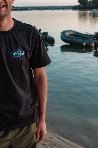 Connected Carper black cotton-blend t-shirt with blue and white geometric fish logo on the chest by the water