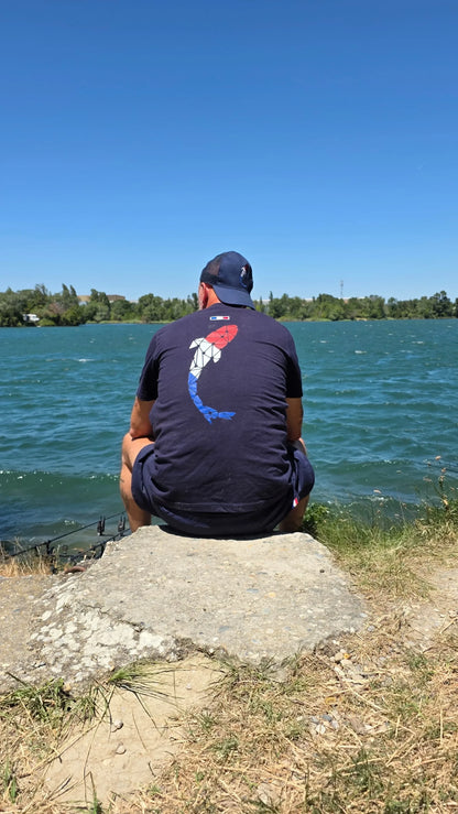 Connected Carper Frenchie trucker cap with breathable mesh back and embroidered logo worn by a fisherman at the lake