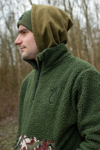 Connected Carper khaki sherpa fleece hoodie with camouflage kangaroo pocket detail worn by a man in a forest setting