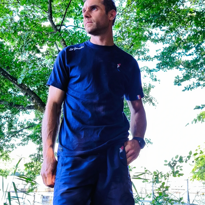Connected Carper La Frenchie navy blue t-shirt and matching shorts with French flag logo worn by a man by the water