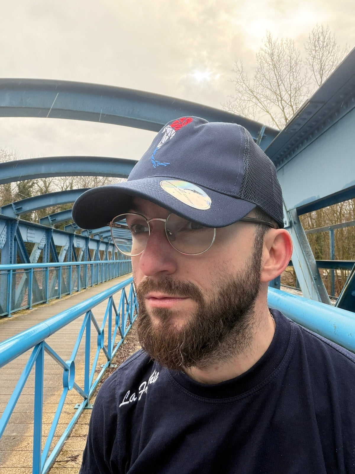 Connected Carper navy blue trucker cap with breathable mesh back and adjustable snapback closure