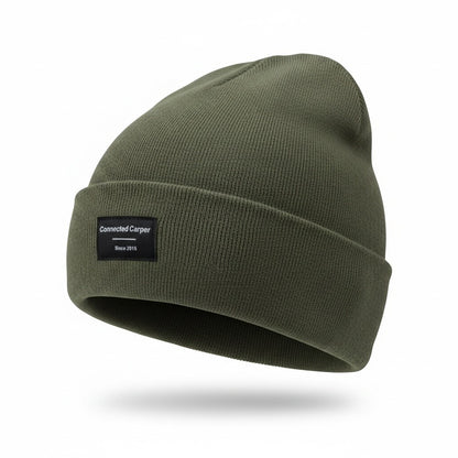 Connected Carper olive green minimalist acrylic beanie with a small black brand patch on the folded cuff
